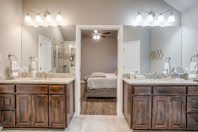 full bathroom featuring a shower stall, lofted ceiling, ceiling fan, and a sink