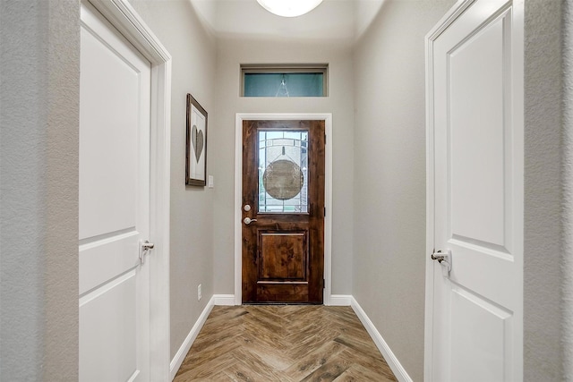 doorway to outside featuring baseboards