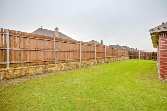 view of yard featuring a fenced backyard