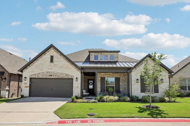 846 Cordoba Ln, Rockwall, TX 75087 - french provincial home featuring a standing seam roof, stone siding, a front yard, driveway, and an attached garage