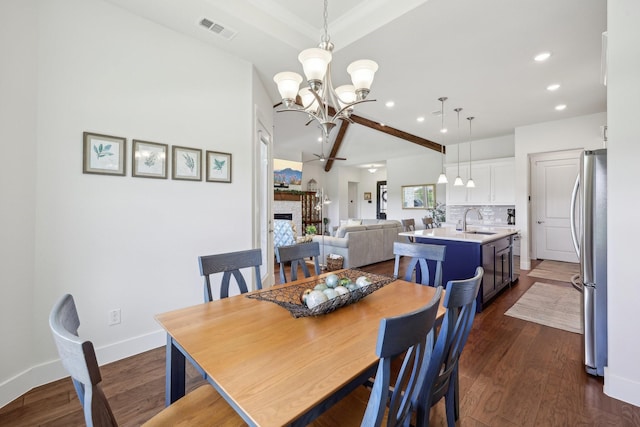 846 Cordoba Ln, Rockwall, TX 75087 - dining room with a chandelier, recessed lighting, dark wood finished floors, lofted ceiling, and baseboards
