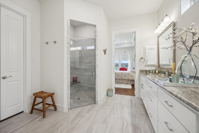 846 Cordoba Ln, Rockwall, TX 75087 - bathroom with ensuite bath, a shower stall, vanity, and baseboards