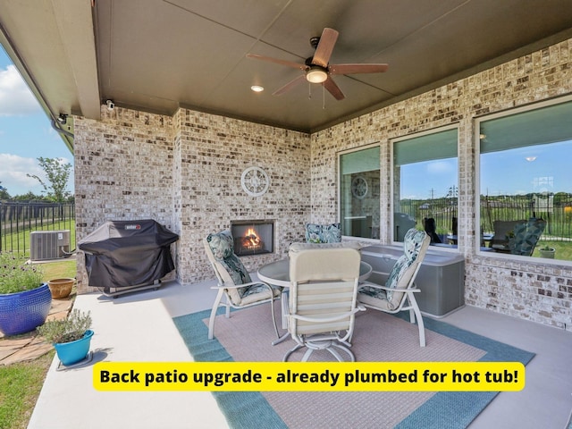 846 Cordoba Ln, Rockwall, TX 75087 - view of patio with a grill, an outdoor brick fireplace, cooling unit, and fence
