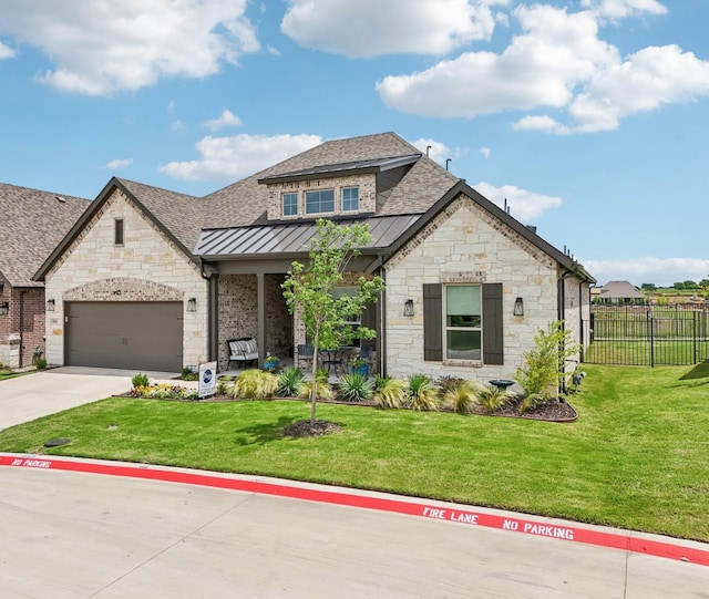 846 Cordoba Ln, Rockwall, TX 75087 - french country inspired facade with stone siding, roof with shingles, a standing seam roof, concrete driveway, and a garage