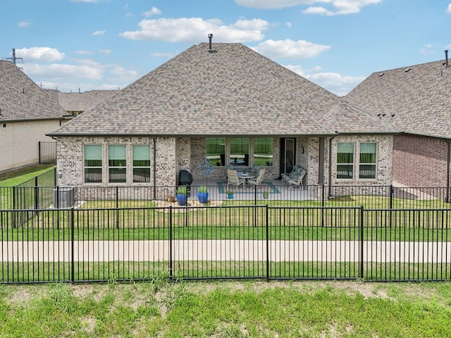 846 Cordoba Ln, Rockwall, TX 75087 - rear view of house with a patio, brick siding, and roof with shingles