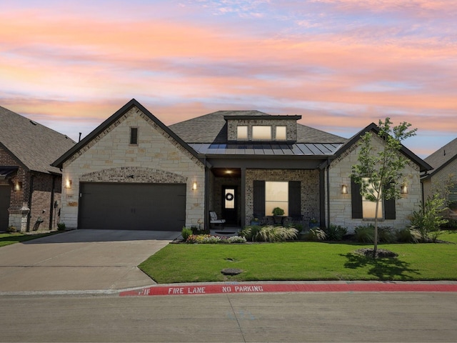 846 Cordoba Ln, Rockwall, TX 75087 - french country home featuring a standing seam roof, a yard, driveway, stone siding, and an attached garage