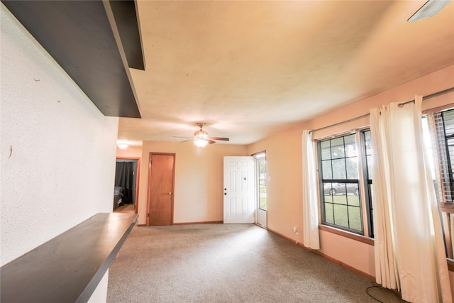1915 W Bond St, Denison, TX 75020 - empty room with a ceiling fan, a wealth of natural light, carpet flooring, and baseboards