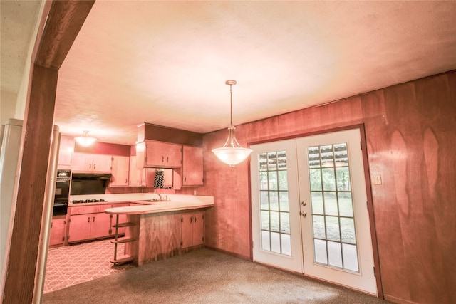 1915 W Bond St, Denison, TX 75020 - kitchen featuring a sink, a peninsula, french doors, light carpet, and light countertops