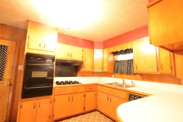 1915 W Bond St, Denison, TX 75020 - kitchen featuring a sink, black appliances, under cabinet range hood, a warming drawer, and light countertops