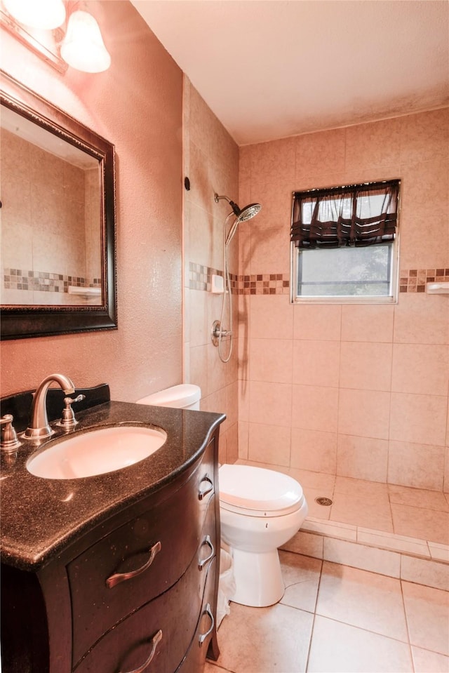 1915 W Bond St, Denison, TX 75020 - full bathroom with toilet, a tile shower, tile patterned flooring, a textured wall, and vanity