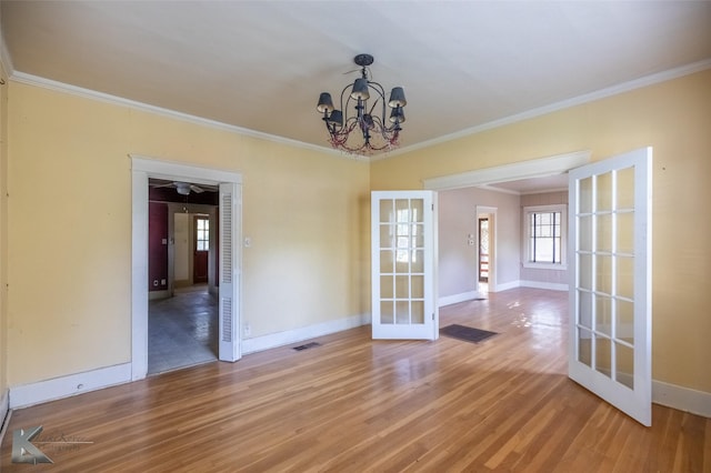 2234 Idlewild St, Abilene, TX 79605 - unfurnished room featuring french doors, ornamental molding, light wood-style floors, baseboards, and a chandelier