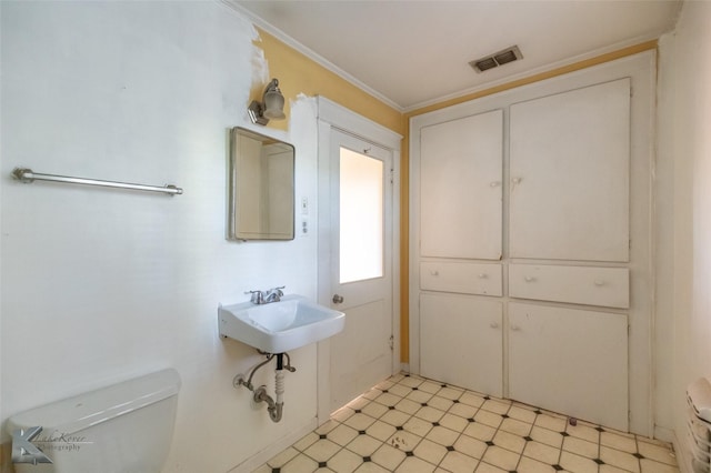 2234 Idlewild St, Abilene, TX 79605 - half bath with toilet, a sink, crown molding, and tile patterned floors