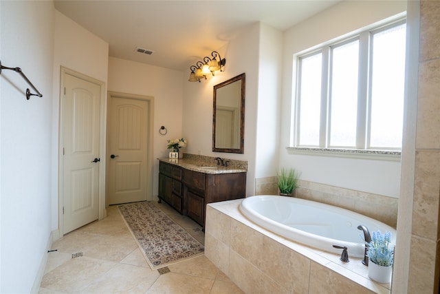 5117 Wakefield Dr, Irving, TX 75038 - bathroom featuring vanity, a bath, visible vents, and tile patterned floors