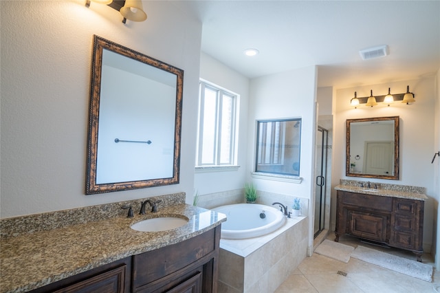 5117 Wakefield Dr, Irving, TX 75038 - bathroom featuring a stall shower, a sink, two vanities, a bath, and visible vents