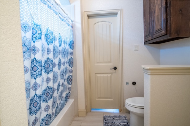 5117 Wakefield Dr, Irving, TX 75038 - bathroom with tile patterned floors, toilet, and shower / bath combo