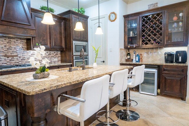 5117 Wakefield Dr, Irving, TX 75038 - kitchen featuring premium range hood, stainless steel appliances, a breakfast bar, ornamental molding, and backsplash