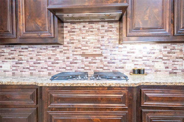 5117 Wakefield Dr, Irving, TX 75038 - kitchen with dark brown cabinetry, extractor fan, and tasteful backsplash
