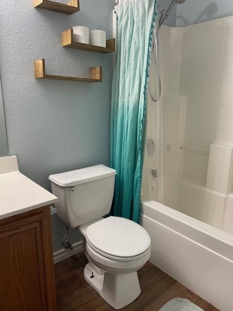 502 Blueberry Hill Ln, Mansfield, TX 76063 - bathroom featuring wood finished floors, a textured wall, vanity, toilet, and shower / bath combo
