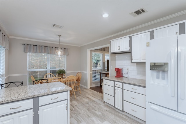 kitchen with crown molding, decorative backsplash, visible vents, and white refrigerator with ice dispenser