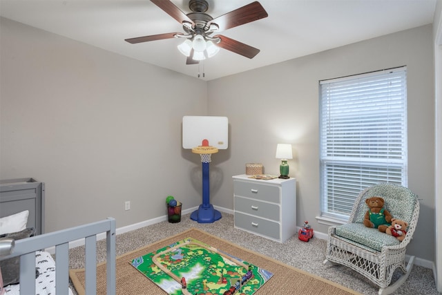 recreation room with baseboards, ceiling fan, and carpet floors