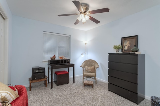 living area with light carpet, baseboards, and ceiling fan