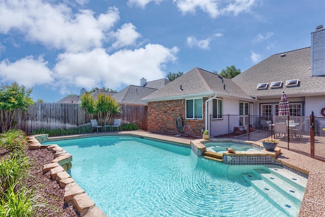 view of pool with a patio, a pool with connected hot tub, and a fenced backyard