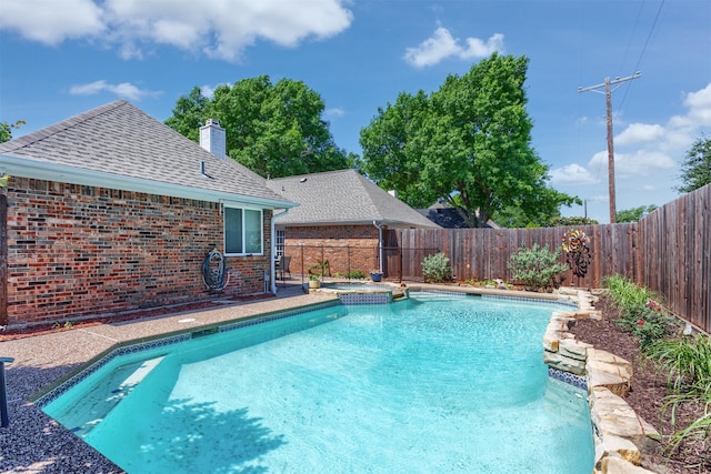 view of swimming pool featuring a fenced backyard and a pool with connected hot tub