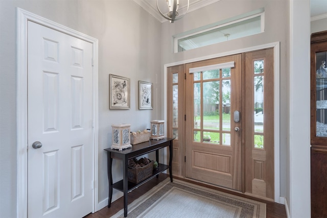 entryway with crown molding, wood finished floors, baseboards, and a healthy amount of sunlight