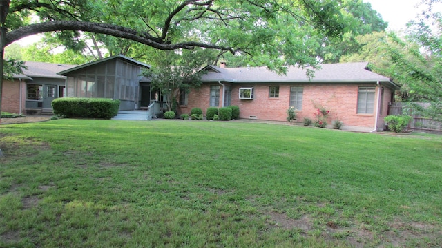 1509 N Gaines St, Ennis, TX 75119 - view of front facade with brick siding, a front yard, a chimney, and a sunroom