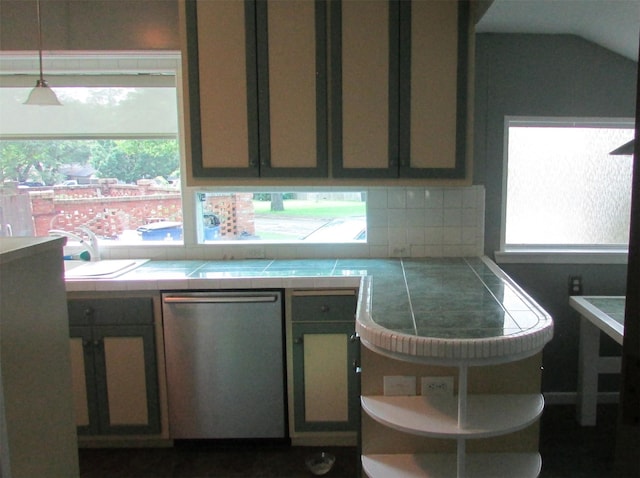 1509 N Gaines St, Ennis, TX 75119 - kitchen with dishwasher, tile counters, backsplash, hanging light fixtures, and lofted ceiling