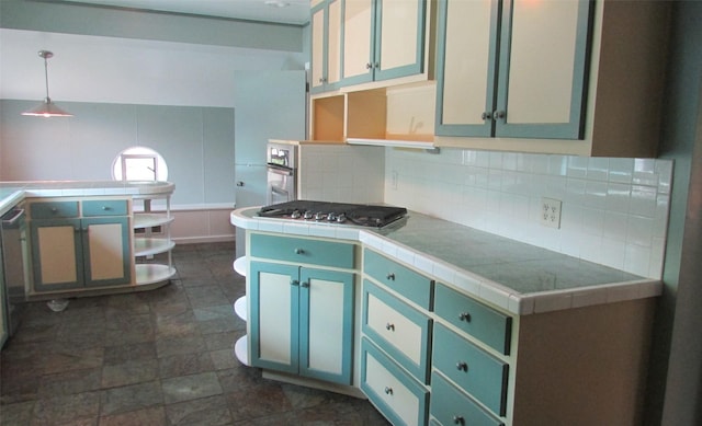 1509 N Gaines St, Ennis, TX 75119 - kitchen featuring open shelves, tile countertops, tasteful backsplash, and appliances with stainless steel finishes
