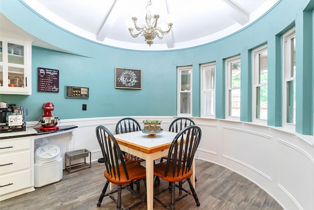 1307 S Westador Dr, Arlington, TX 76015 - dining area with a chandelier, beam ceiling, wood finished floors, wainscoting, and a decorative wall