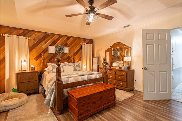 1307 S Westador Dr, Arlington, TX 76015 - bedroom with wood finished floors, wooden walls, and a ceiling fan