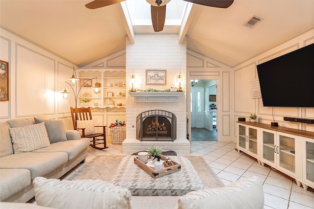 1307 S Westador Dr, Arlington, TX 76015 - living room with a decorative wall, ceiling fan, light tile patterned floors, a fireplace, and a skylight