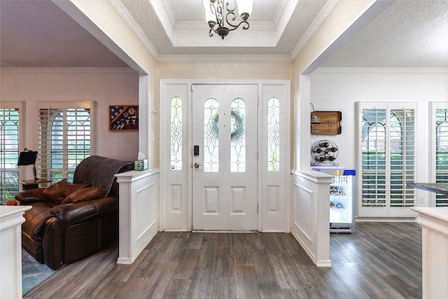 1307 S Westador Dr, Arlington, TX 76015 - entryway featuring dark wood-style floors, crown molding, and a chandelier