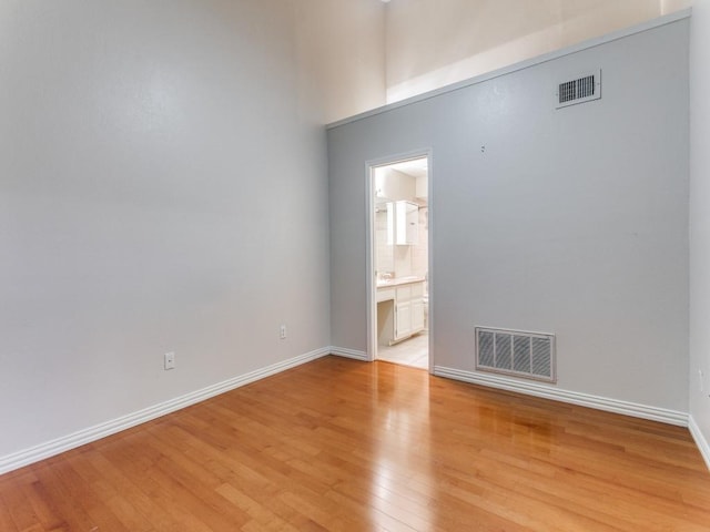 4242 N Capistrano Dr Unit 203, Dallas, TX 75287 - unfurnished room with baseboards, light wood-type flooring, and visible vents