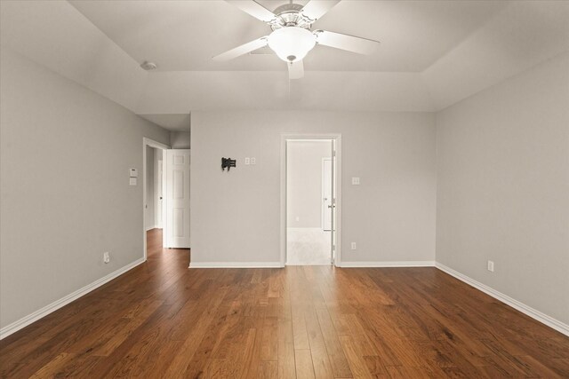 unfurnished room featuring dark wood finished floors, baseboards, ceiling fan, and lofted ceiling