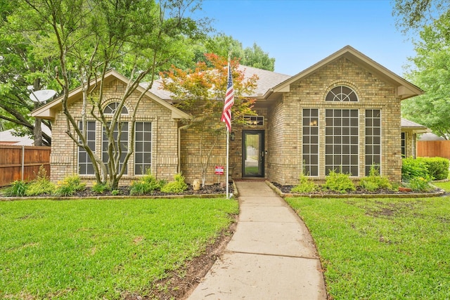 single story home featuring brick siding