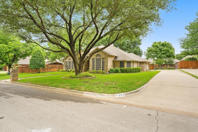 view of front of property with brick siding and driveway