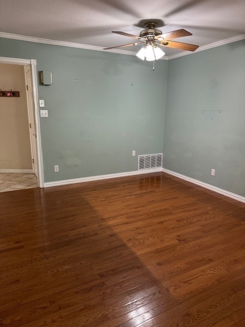 7249 Peden Rd, Azle, TX 76020 - spare room featuring wood finished floors, visible vents, crown molding, a ceiling fan, and baseboards