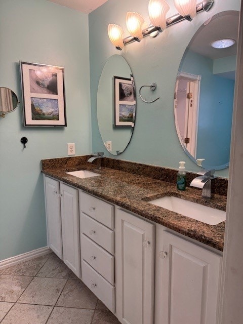 7249 Peden Rd, Azle, TX 76020 - bathroom featuring baseboards, double vanity, and a sink