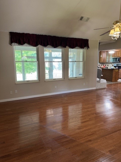 7249 Peden Rd, Azle, TX 76020 - unfurnished living room with baseboards, a ceiling fan, visible vents, and wood finished floors