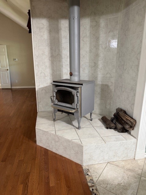 7249 Peden Rd, Azle, TX 76020 - room details featuring a wood stove, baseboards, and wood finished floors