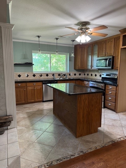 7249 Peden Rd, Azle, TX 76020 - kitchen featuring brown cabinetry, stainless steel appliances, crown molding, and decorative backsplash