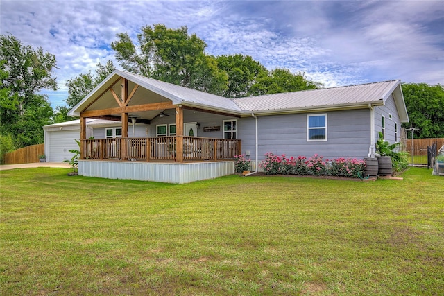 185 Seminole Trl, East Tawakoni, TX 75472 - back of property featuring a yard, metal roof, ceiling fan, and fence