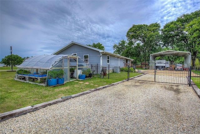 185 Seminole Trl, East Tawakoni, TX 75472 - view of home's exterior with a yard, fence, a greenhouse, and driveway
