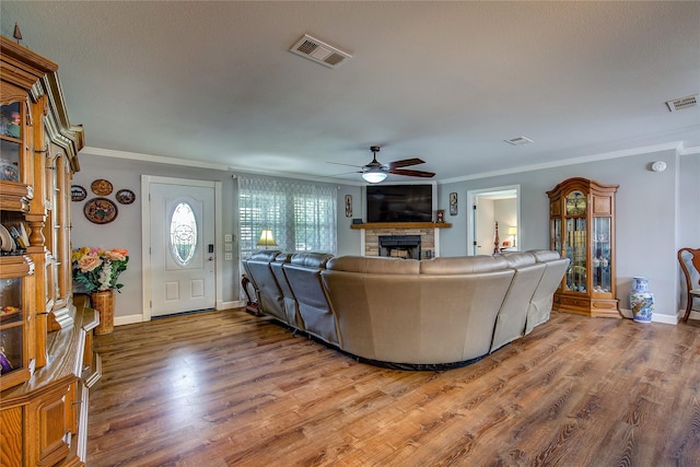 185 Seminole Trl, East Tawakoni, TX 75472 - living room featuring ceiling fan, crown molding, a fireplace, and visible vents