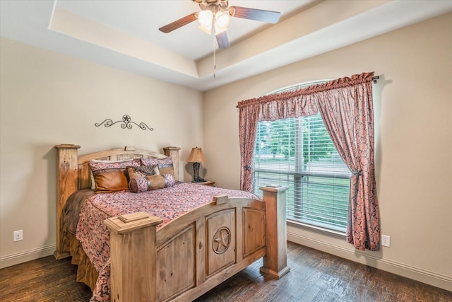 360 Rs County Road 3419, Emory, TX 75440 - bedroom with dark wood-style floors, a tray ceiling, baseboards, and a ceiling fan