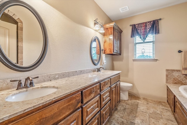 360 Rs County Road 3419, Emory, TX 75440 - bathroom with toilet, a garden tub, double vanity, baseboards, and stone finish floors