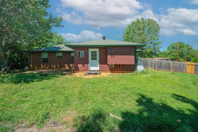 1022 Wootton Ave, Bridgeport, TX 76426 - back of property featuring a yard, entry steps, and fence
